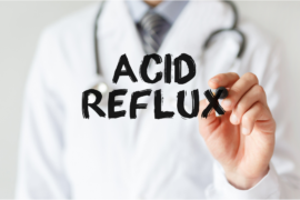 Medical professional writing "ACID REFLUX"