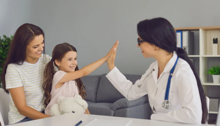 pediatric treatment- child high-fiving doctor