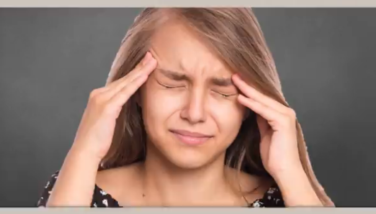 Episodic Migraine - migraine research study - woman holding her head in pain